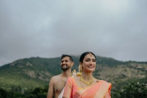 Couple in traditional attire outdoors.