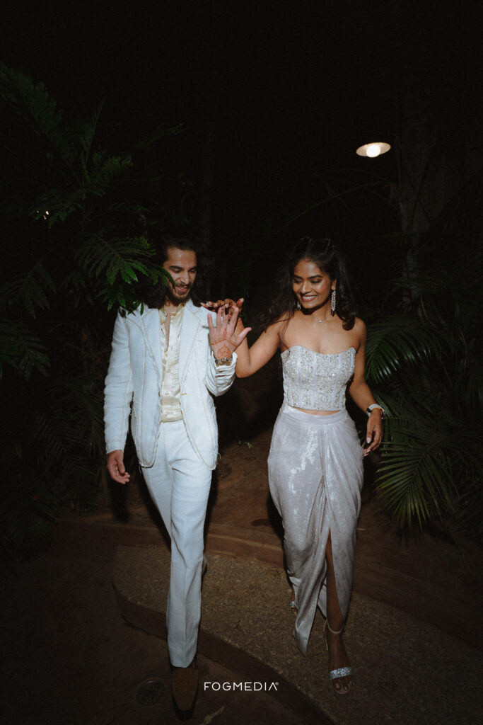 Candid wedding photography Bangalore featuring a stylish couple walking together at an upscale Indiranagar venue.