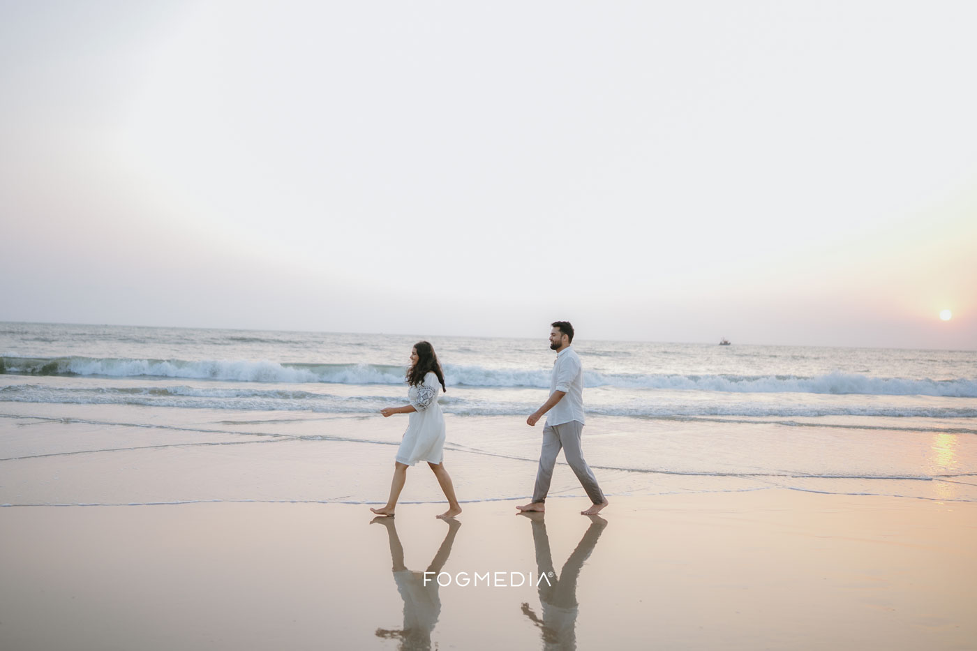 Beach pre-wedding shoot in Kannur by Fog Media, couple on the shoreline at golden hour
