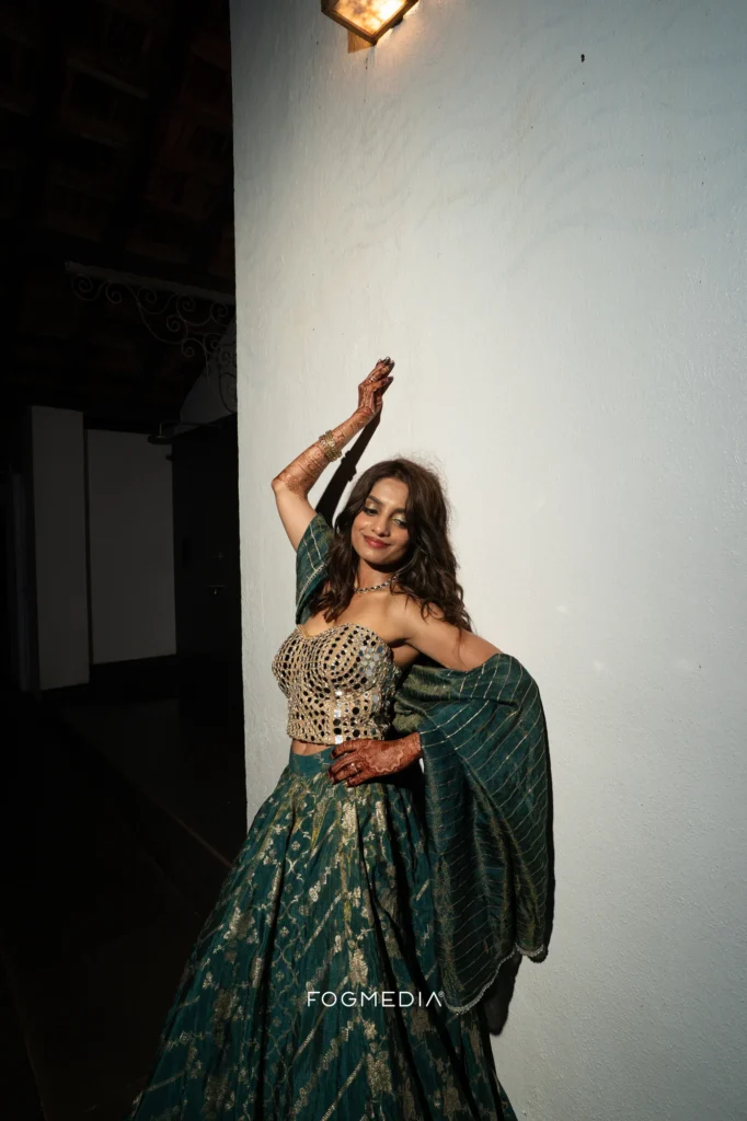 Salonee dancing with one arm raised at the Sangeet, Prainha Resort by the Sea