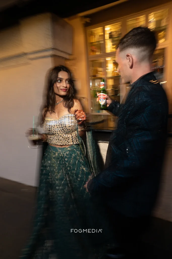 Salonee and David at the bar during the Sangeet at Prainha Resort, caught in motion blur