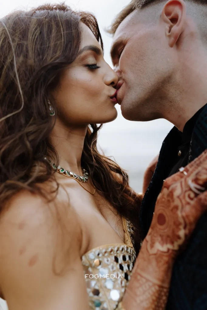 Salonee and David kissing at dusk near the headland at Dona Paula, Goa