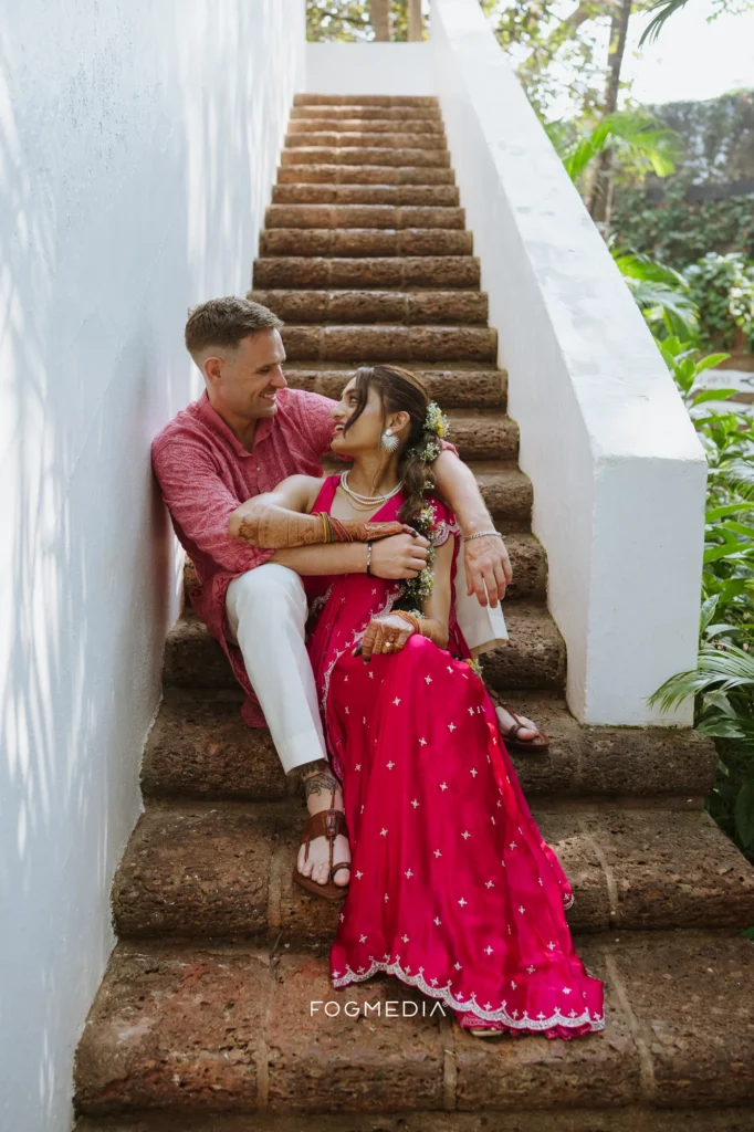 Salonee and David sitting together on the stone staircase at Prainha Resort by the Sea