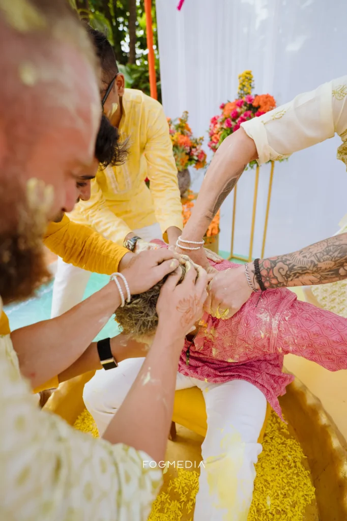 Turmeric being pressed into Salonee's hands during the haldi at Prainha Resort